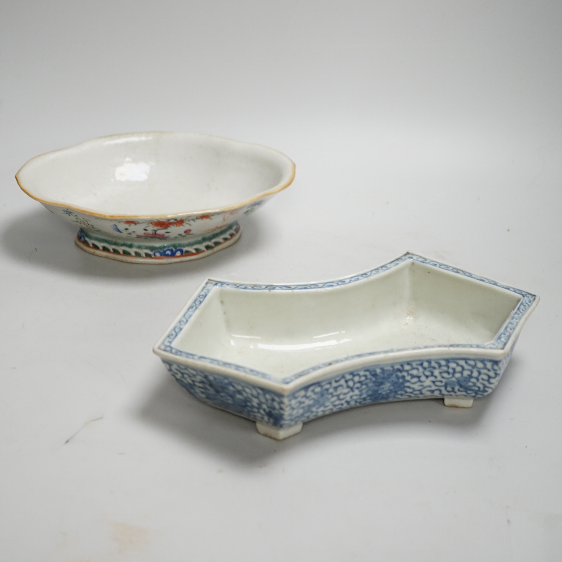 A 19th century Chinese blue and white ingot shaped dish and a famille rose footed dish, the largest 25cm wide (2)